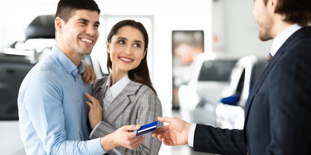 Couple handing over credit card to purchase an RV